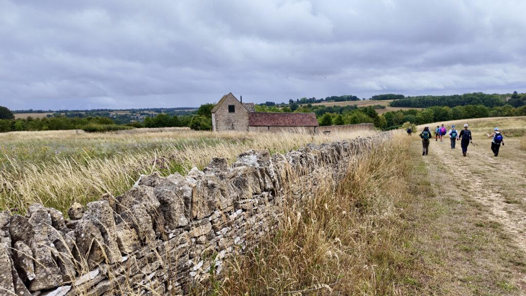Walking trip in the Cotswolds with stone cottages and rolling hills